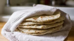 finished flatbread in a stack inside towel