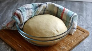 sourdough inside bowl covered with cloth for hours